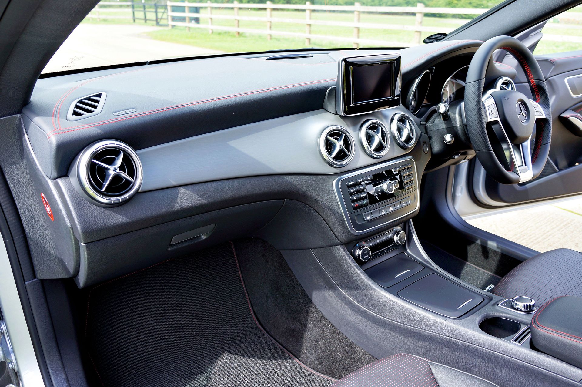 Sleek car interior showcasing a contemporary dashboard and steering wheel design.